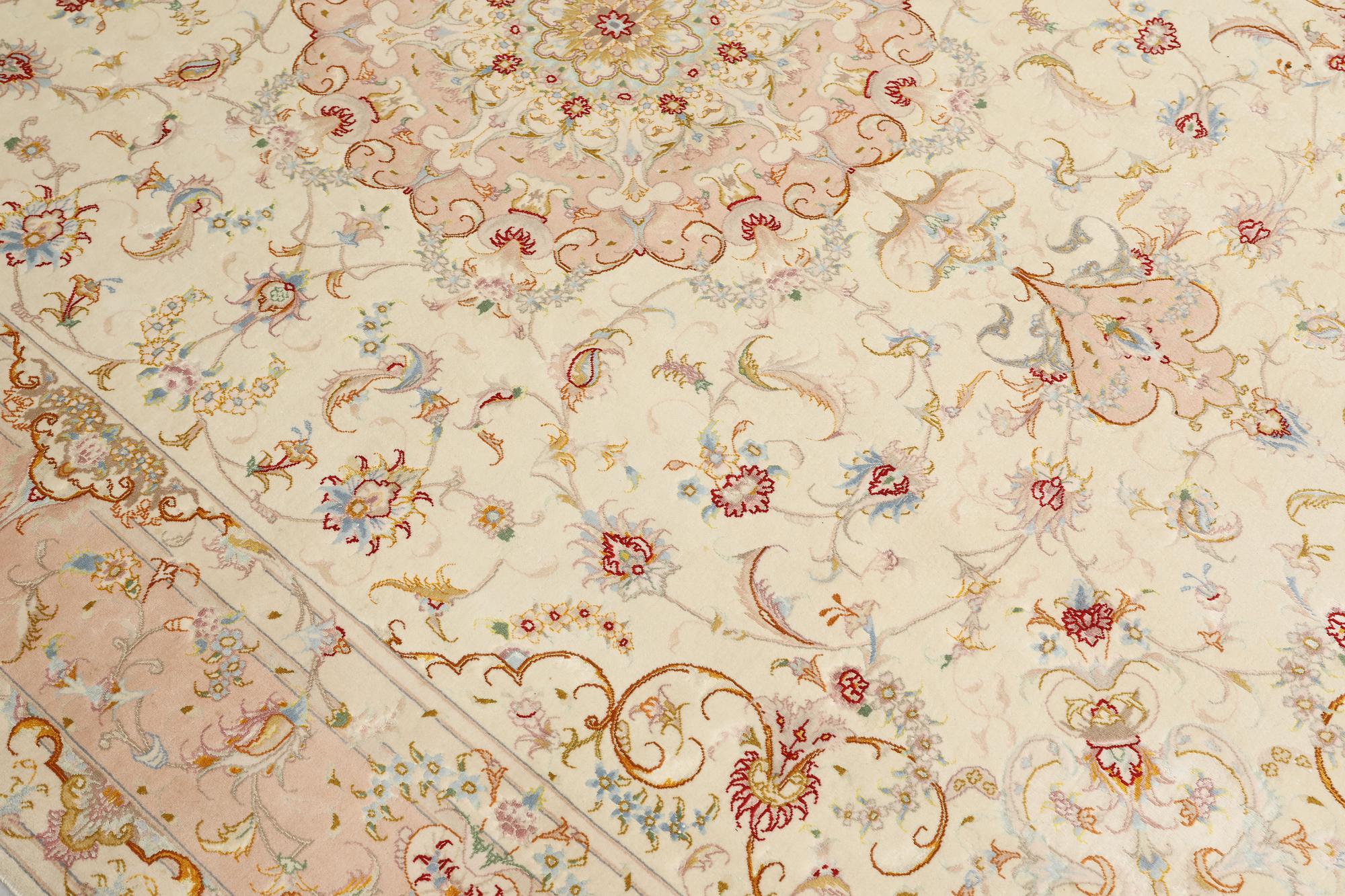 A Tabriz part silk carpet, signed, 305 x 203 cm.