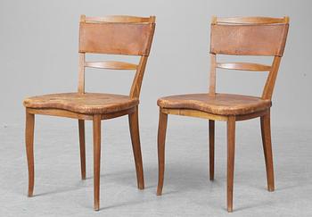 A pair of Carl-Axel Acking mahogany and brown leather chairs, Svenska Möbelfabrikerna Bodafors.