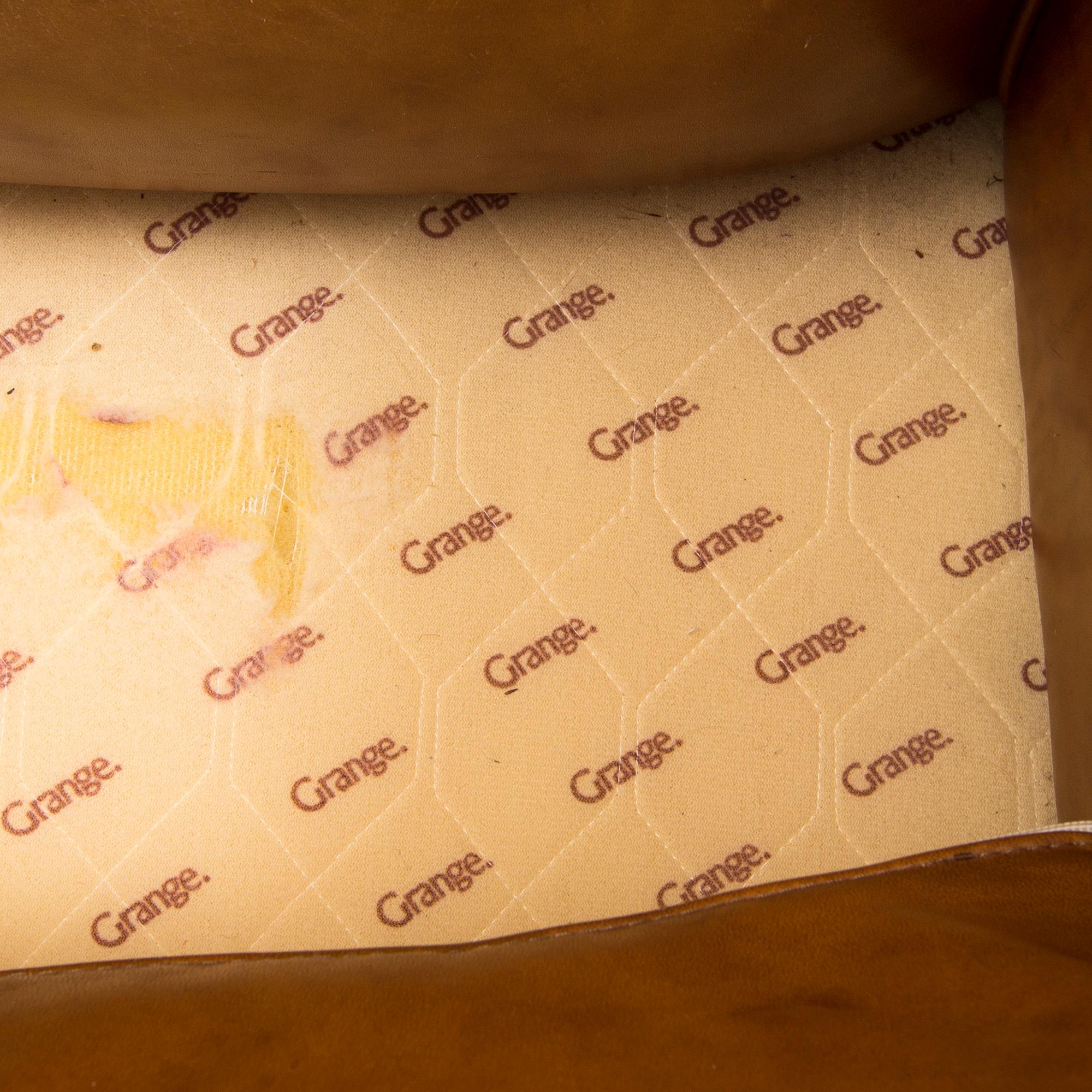 A brown leather armchair by grange, the second half of the 20th century.