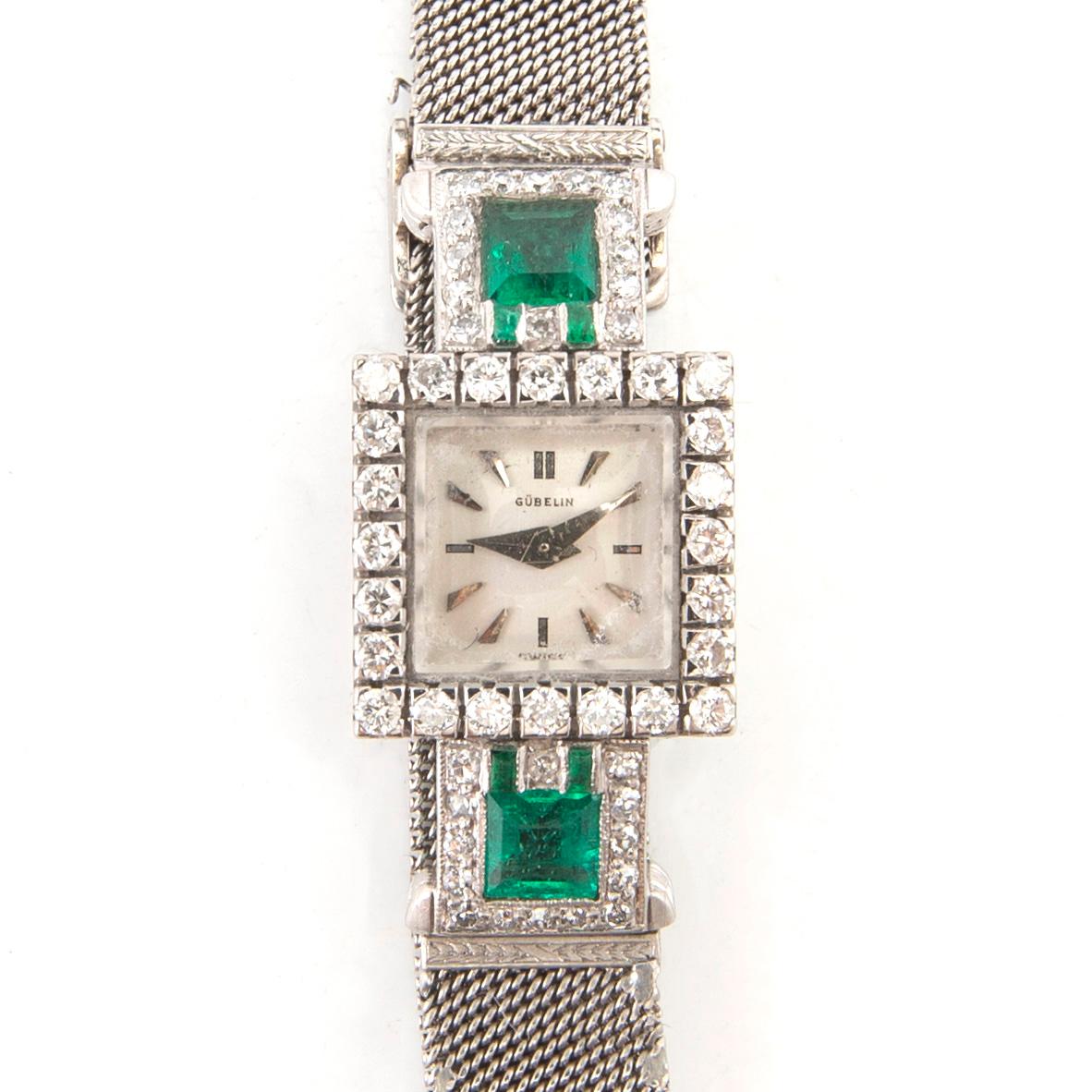 Gübelin bracelet watch in 950 platinum with round brilliant-cut and single-cut diamonds as well as step-cut emeralds.