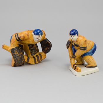 LISA LARSON, two stoneware figurines, "Ishockeyspelare", Gustavsberg. Designed in 1973.