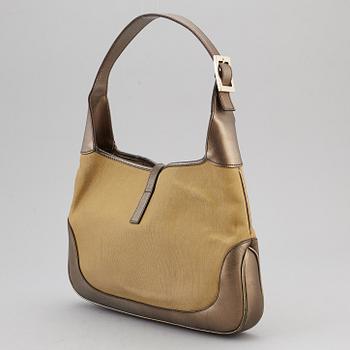 GUCCI, a metallic bag.
