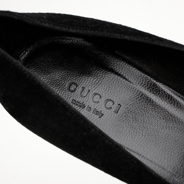 GUCCI, a pair of black suede pumps.