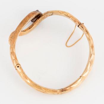 An 18K gold snake bangle with rose-cut diamonds.