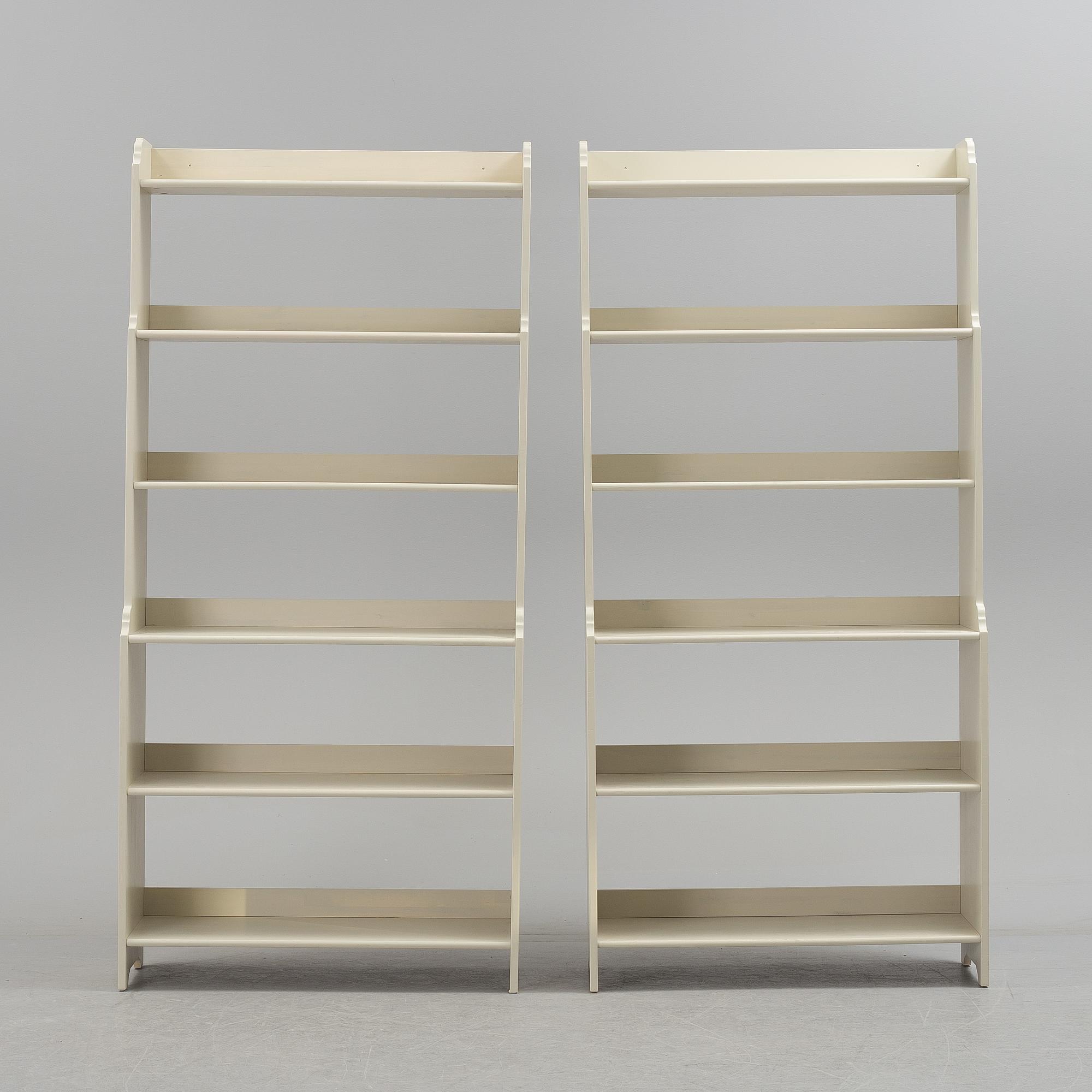 A pair of IKEA "Leksvik" painted bookcases.