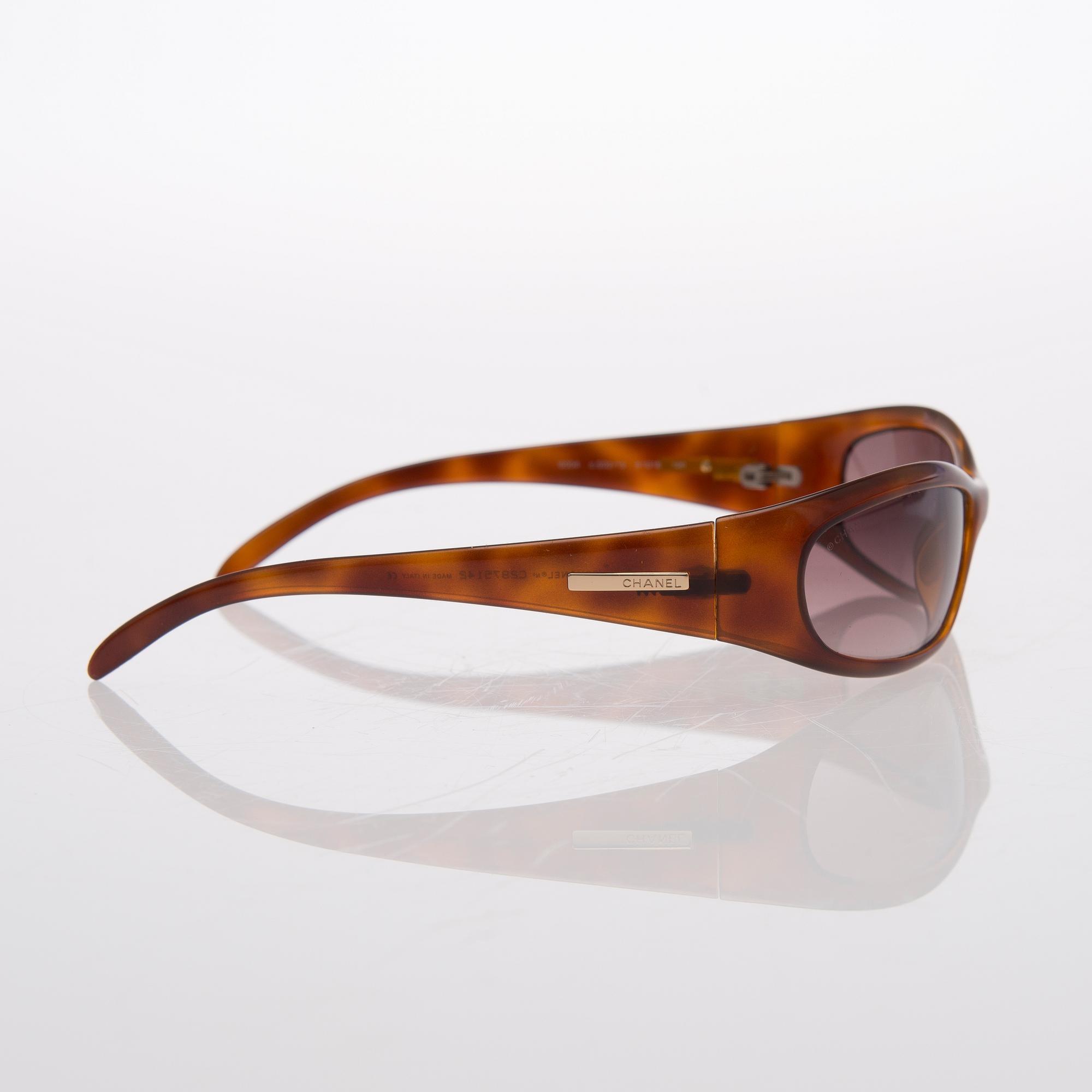 Two Pairs of Sunglasses, Prada and Chanel.