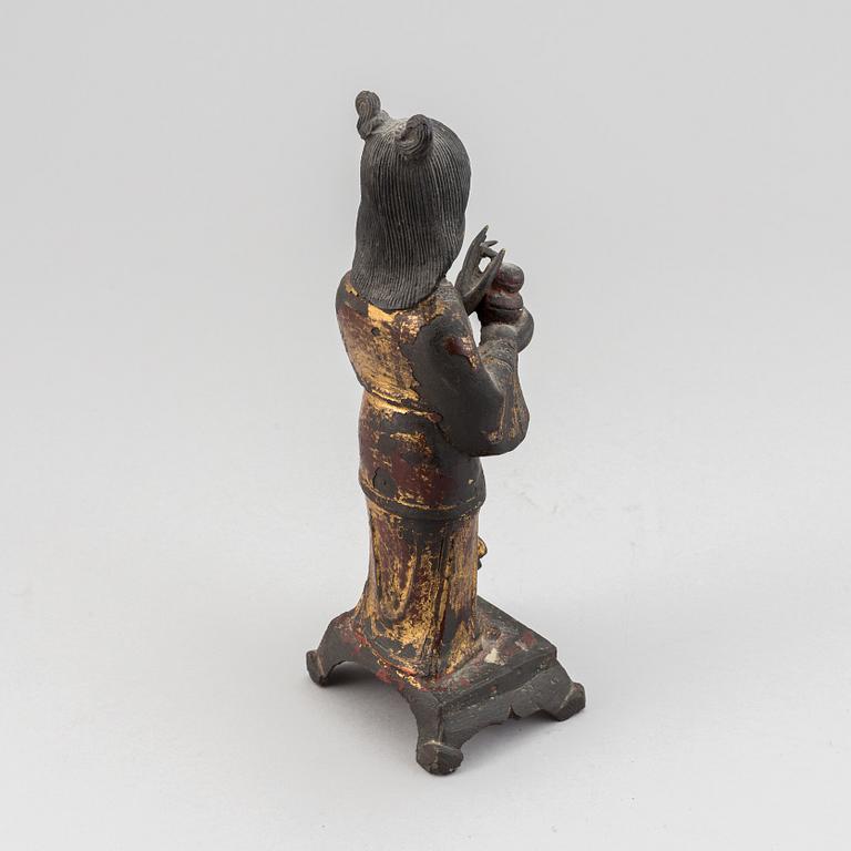 A bronze figure of a standing deity holding a jar, Qing dynasty, 19th Century.