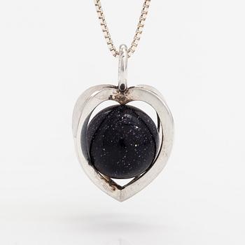 Elis Kauppi, A silver necklace with a purple goldstone. Kupittaan kulta, Turku.