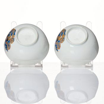 A pair of armorial cups with saucers, Qing dynasty, Qianlong (1736-95).