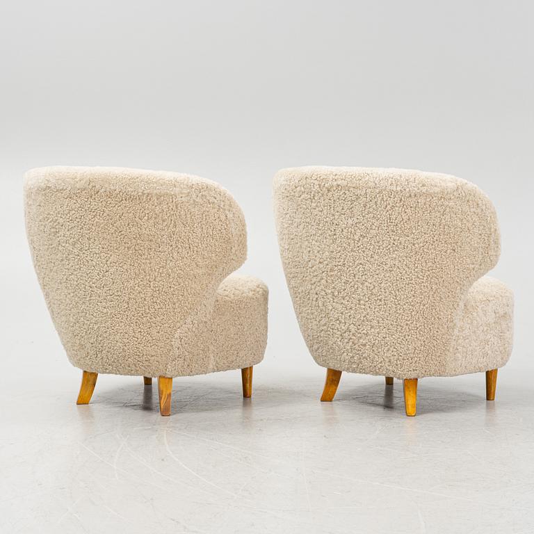 A pair of Scandinavian Modern 1940s cheepskin armchairs.