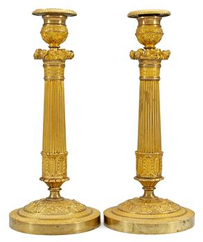 1041. A pair of French Empire candlesticks.