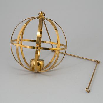 A brass pendulum candle model X10, by Skultuna.