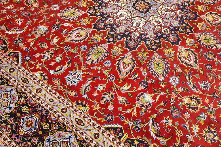 A Keshan carpet, part silk, signed, approx. 398 x 270 cm.