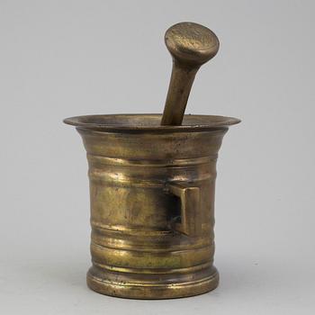 A 18th century brass mortar with pestle.