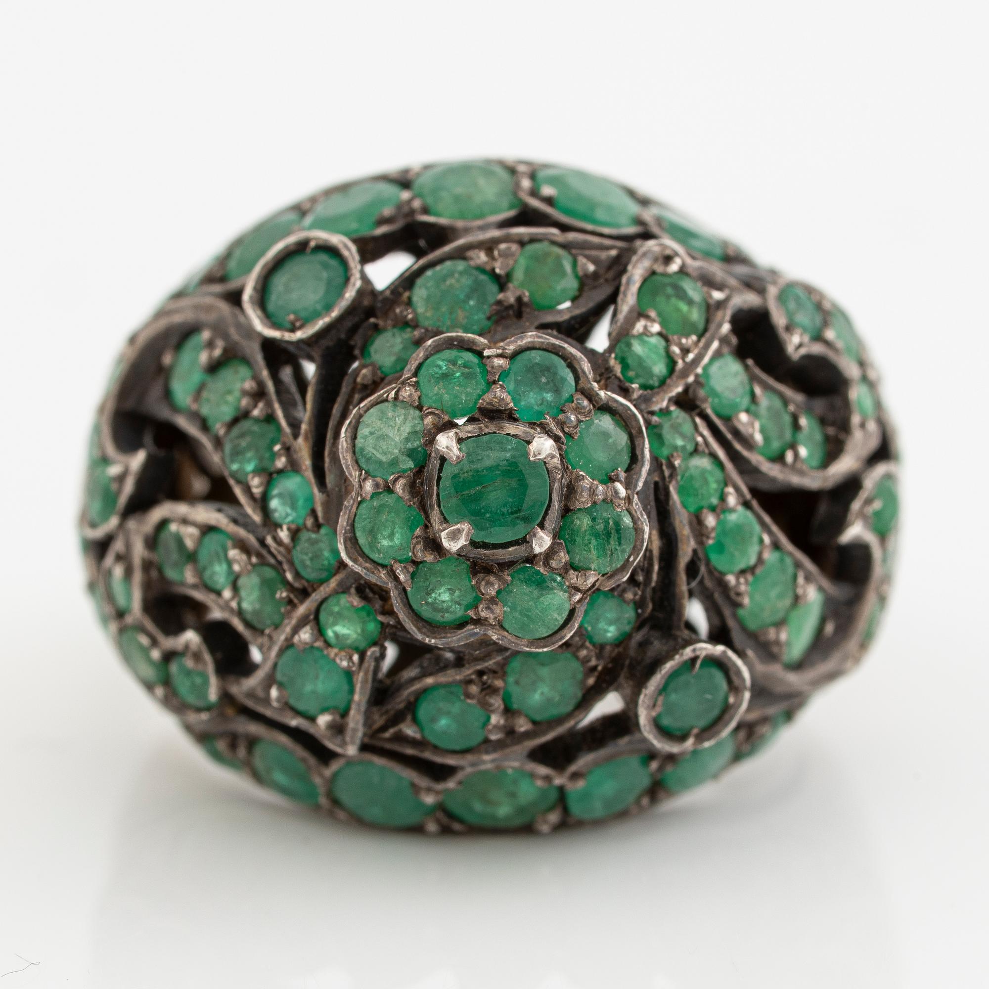 Silver ring with green stones.