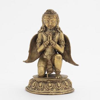 A copper alloy figure of bewinged dignitary, Nepal, 20th Century.