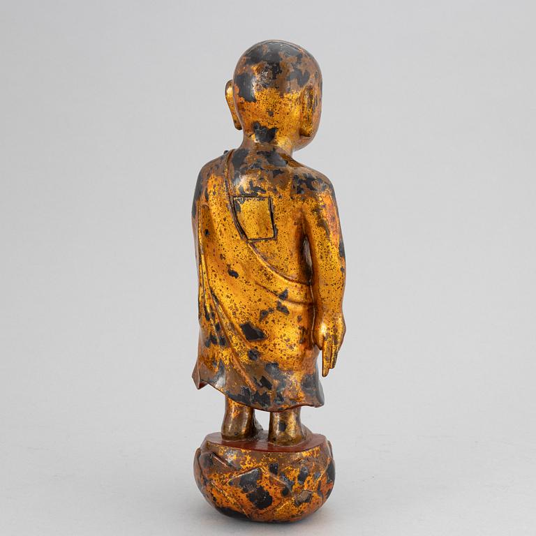 A Chinese wood gilt and lacquer sculpture of a boy, 20th Century.