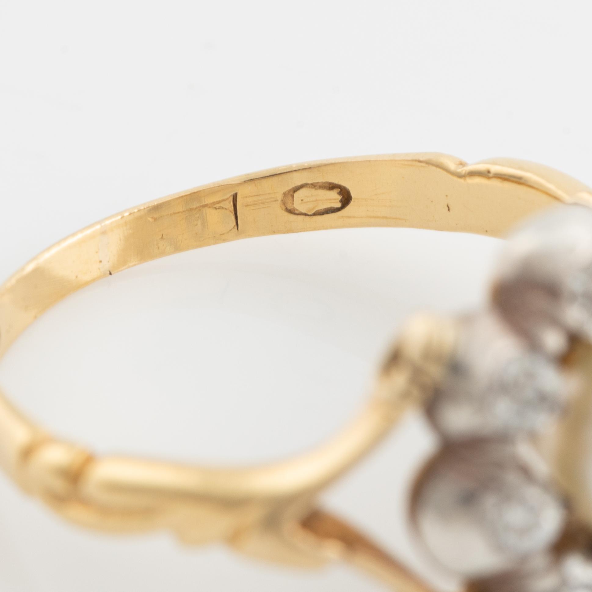 An 18K gold ring and silver set with a pearl and old-cut diamonds.