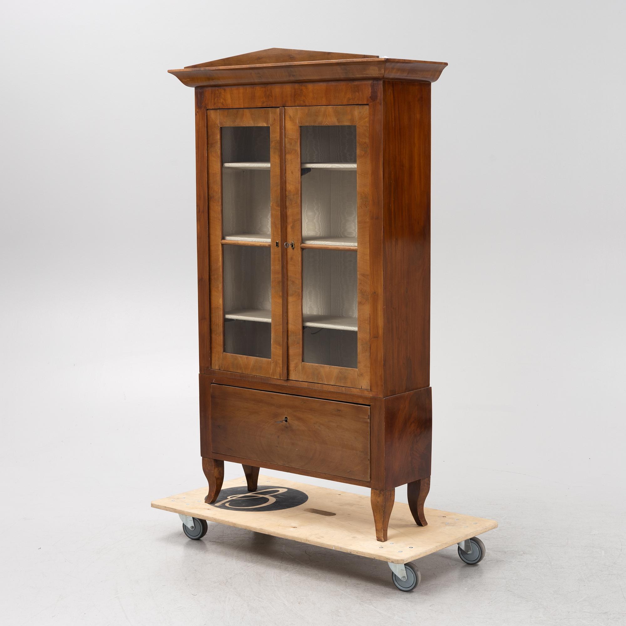 A mahogany veneered book cabinet. 19th Century.