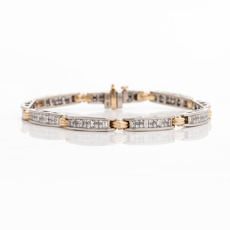 A 14K gold/white gold bracelet set with princess- and baguette-cut diamonds.