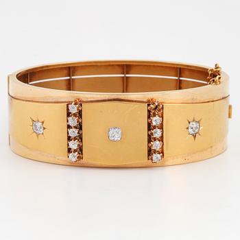 An 18K gold bracelet set with old-cut diamonds.
