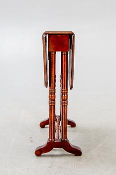 A 20th century English mahogany folding table.