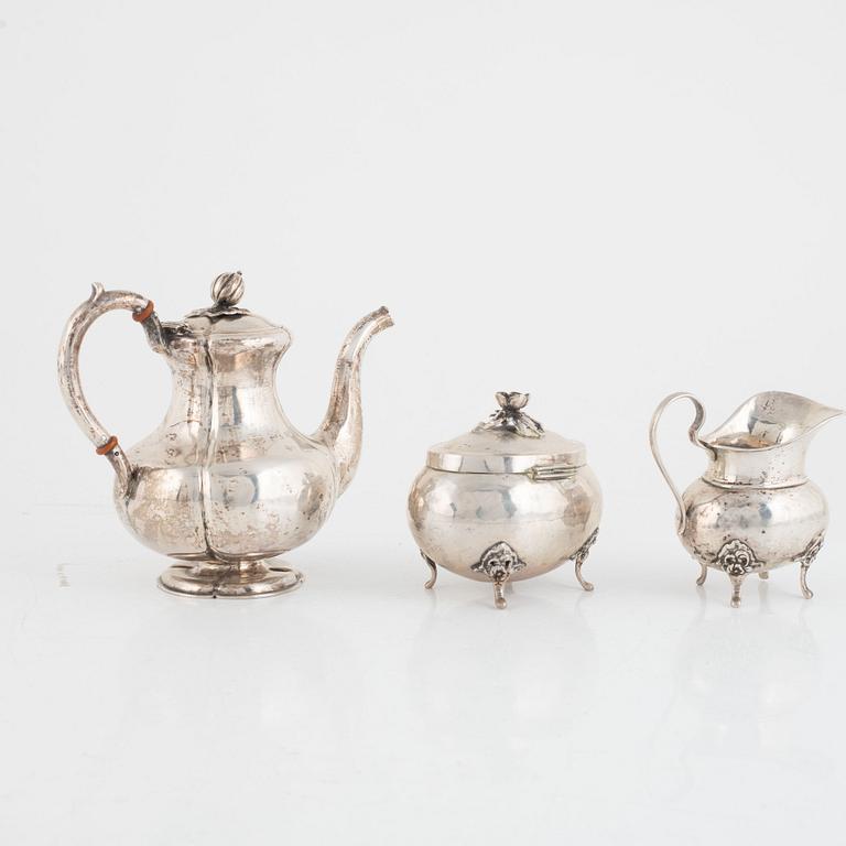 A silver coffee pot, a creamer and a sugarbowl, including S:t Petersburg, Russia 1858.