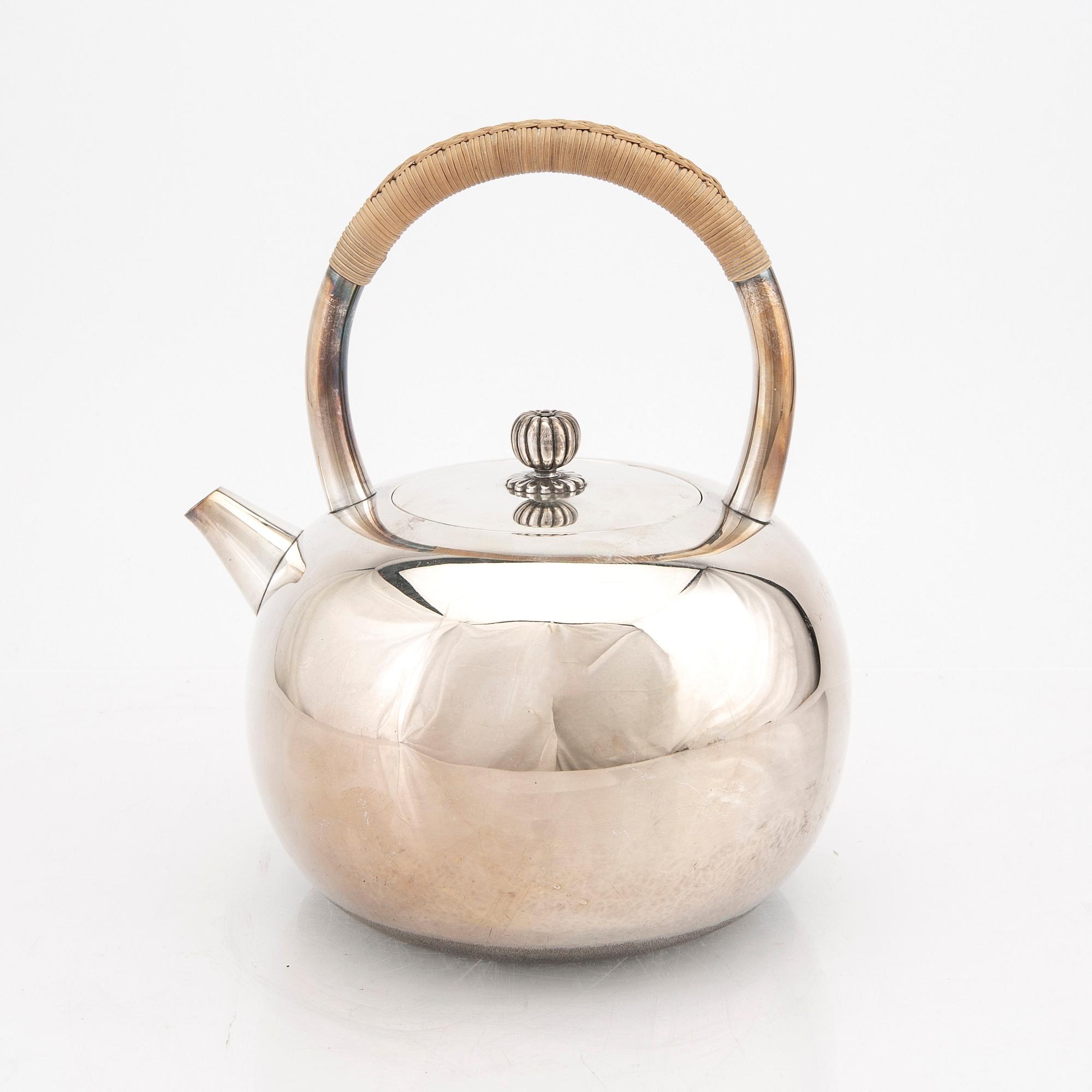 A Japanese early 20th century sterling silver tea pot.