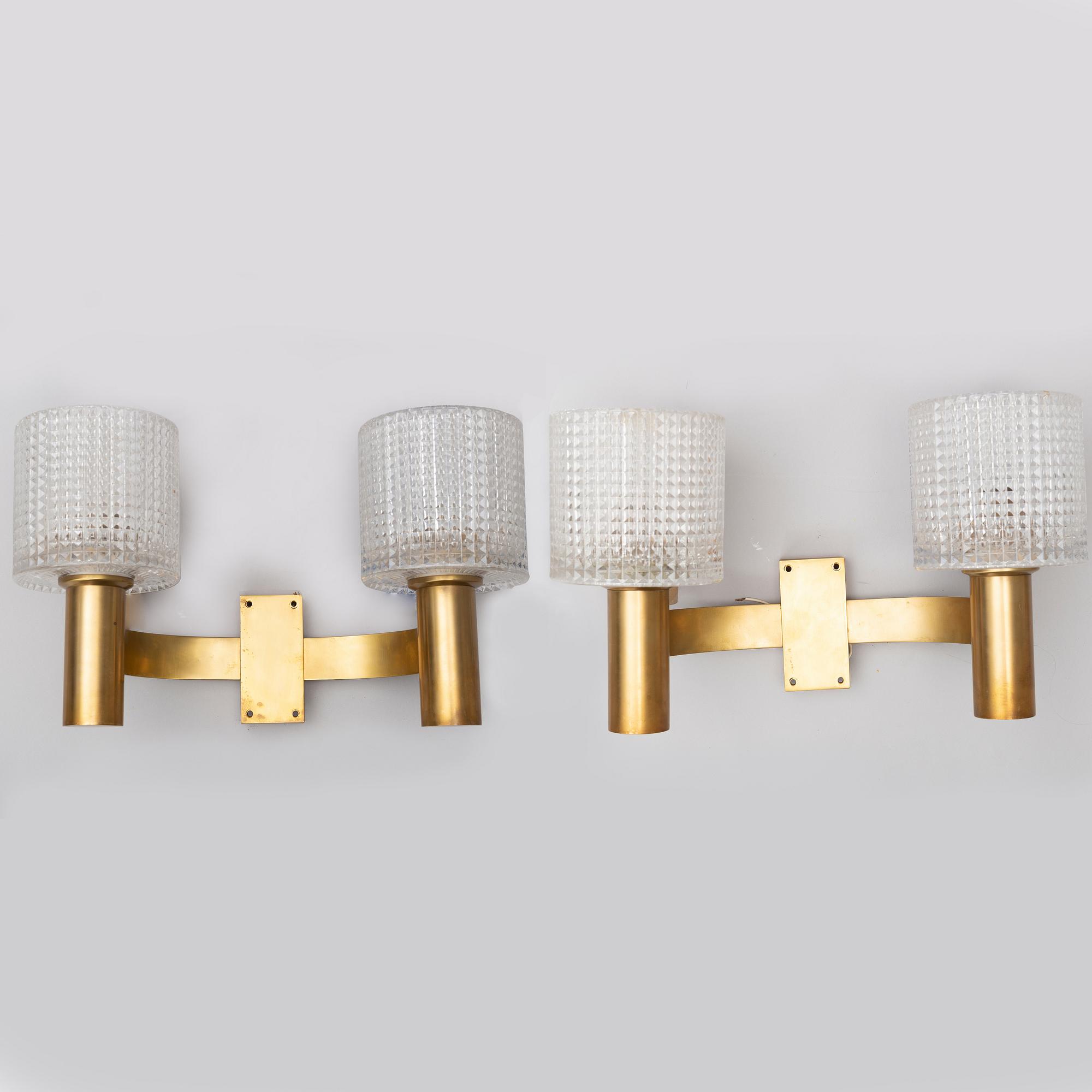 A pair of the 20th century brass and glass wall lights.