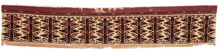 ANTIQUE TURKMEN FRAGMENT. Probably fragment of a kapunuk or a jollar. 24 x 130 cm.