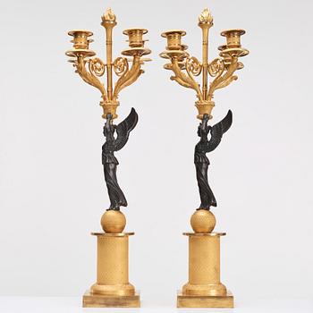 A pair of Empire four light candelabra.