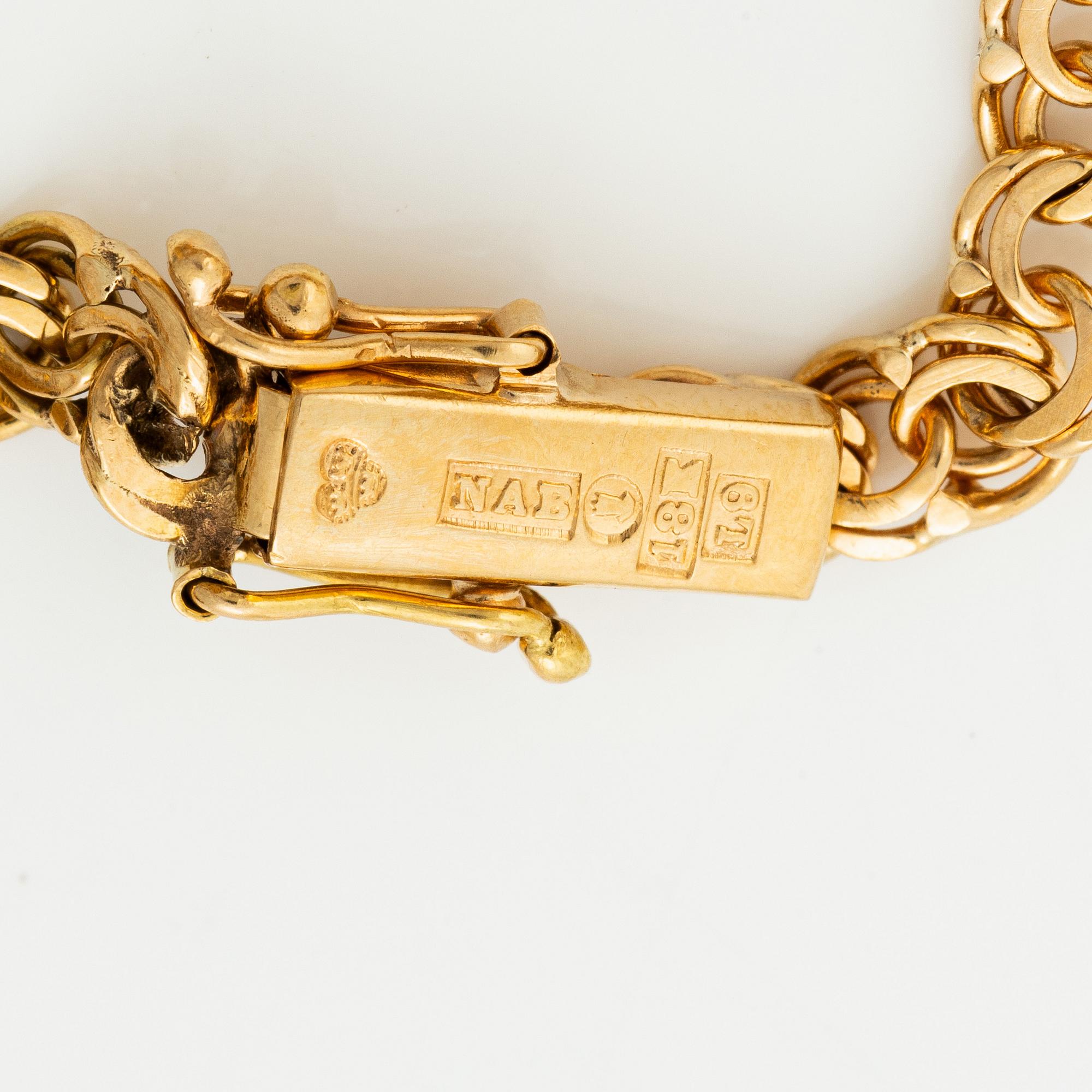 Bracelet, 18K gold bismarck link. With charms.