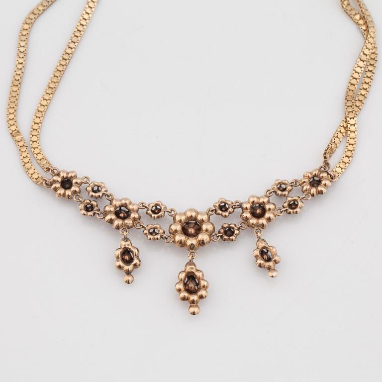 A necklace set with rose-cut diamonds.