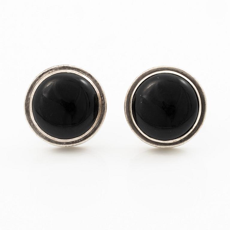 Cufflinks, a pair in silver with cabochon-cut stones.