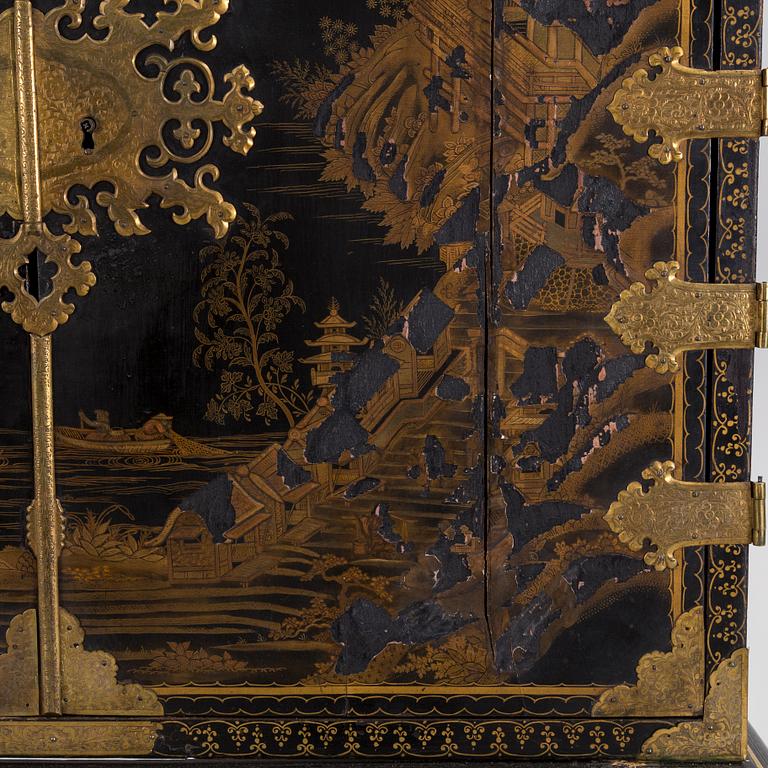 AN early 18TH CENTURY PROBABLY ENGLISH Japanned laquer cabinet on stand.