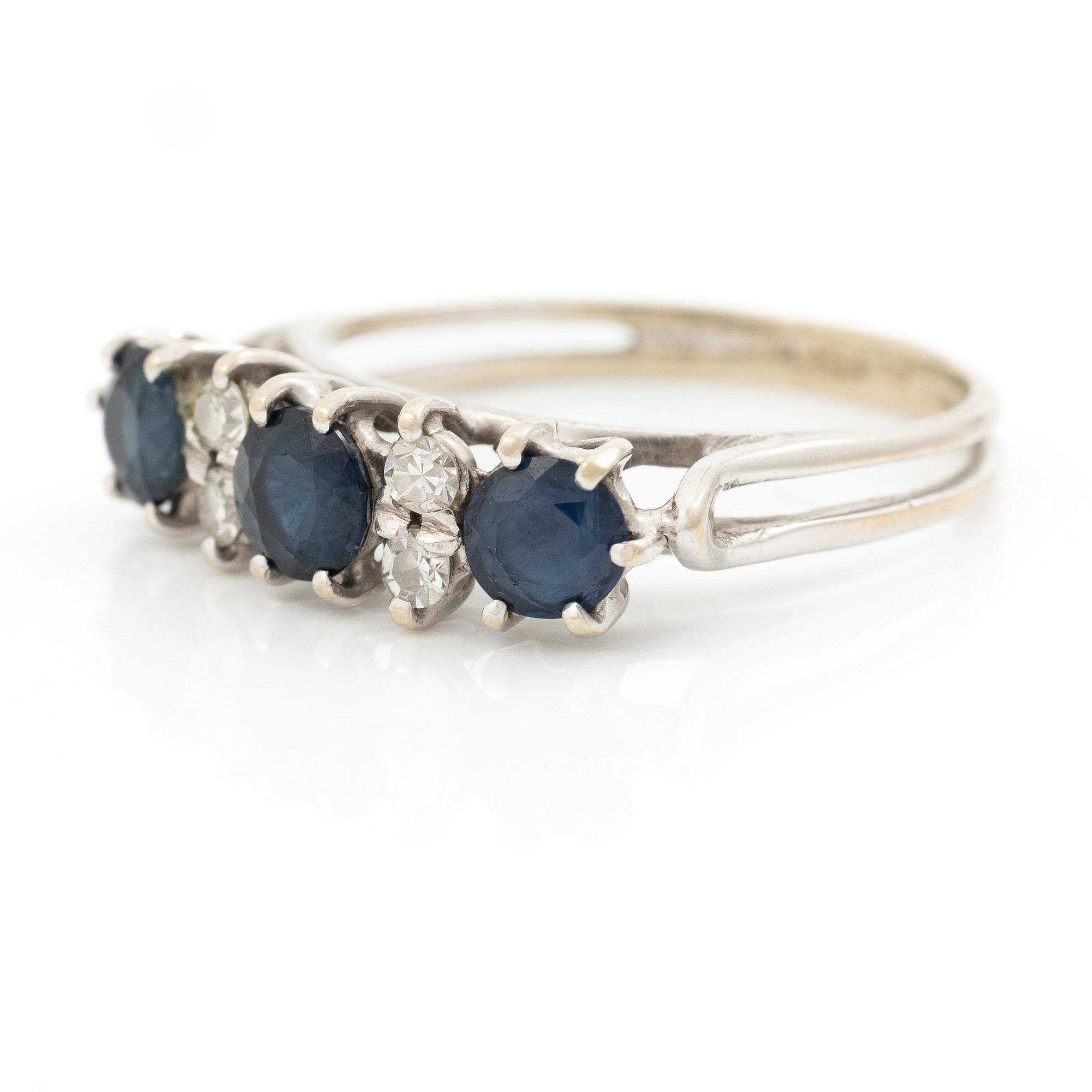 Ring, 18K white gold, set with three sapphires and single-cut diamonds.