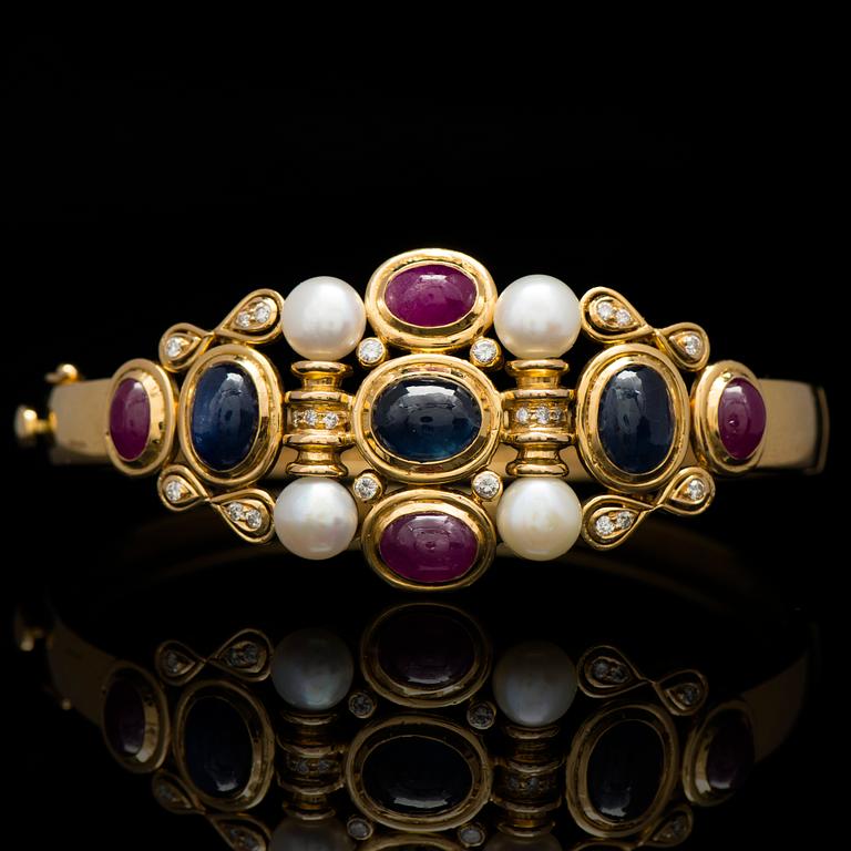 A BRACELET, cabochon cut sapphires and rubies, cultured pearls, brilliant cut diamonds, 18K gold.