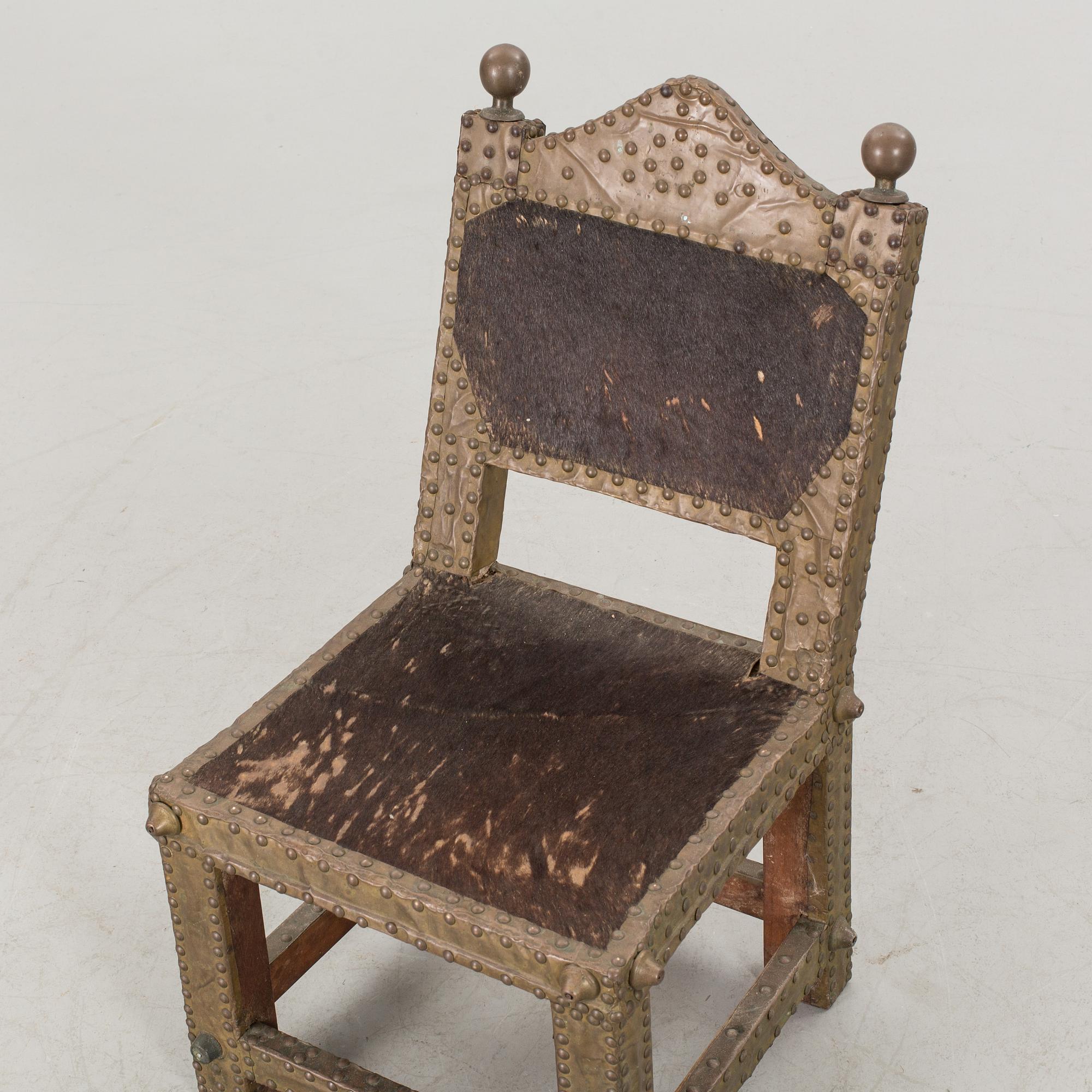 An Ashanti chair, Ghana, hardwood with brass studs, ca 1900.