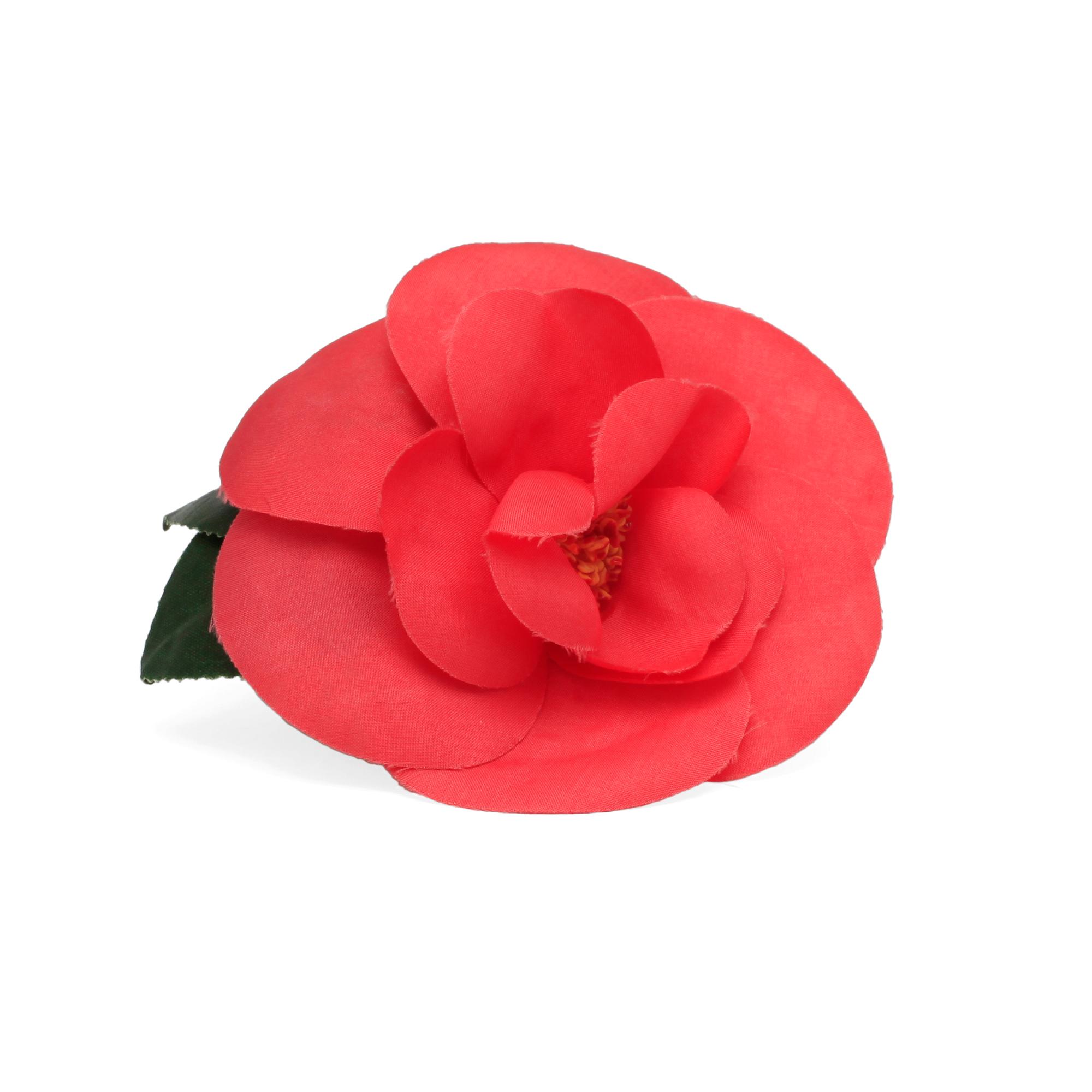 CHANEL, a red brooch.