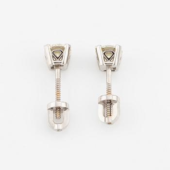 A pair of 18K gold earrings with round brilliant-cut diamonds.