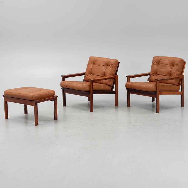 Illum Wikkelsö, a pair of 'Capella' armchairs and an ottoman, second half of the 20th century.