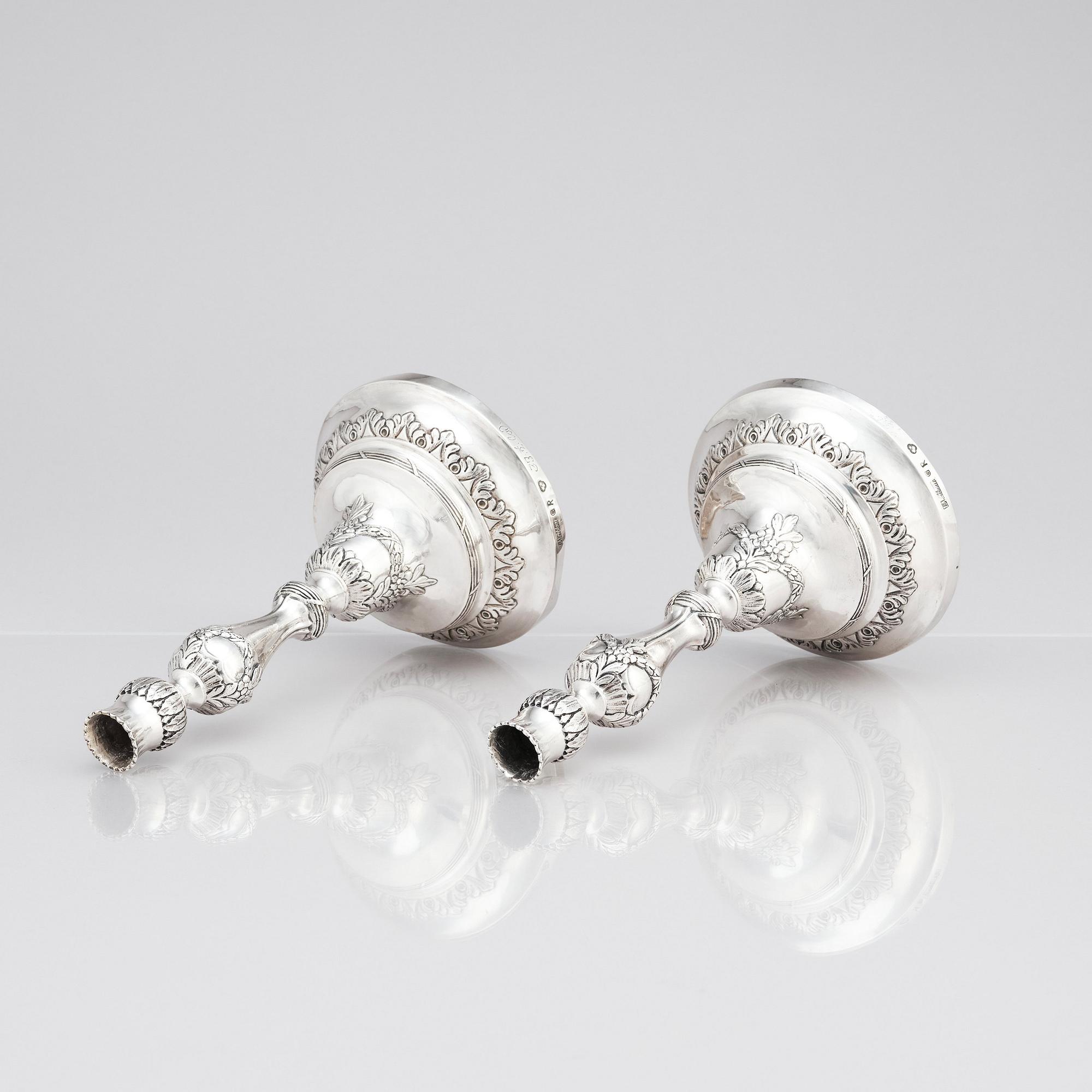 A pair of Swedish 18 century silver candelabras, mark of Lars Åkerblom Gävle 1775, arms by Christian Kullberg.