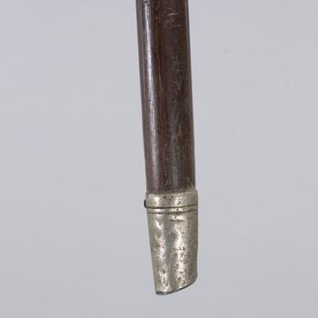 A CANE WITH SILVER MOUNTING, 1910.