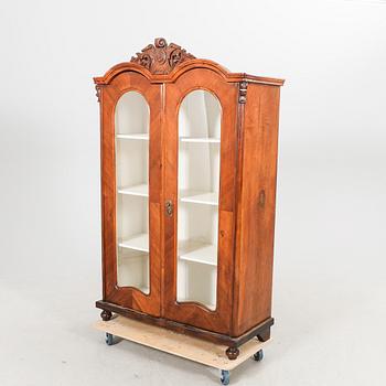 A walnut display cabinet around 1900.