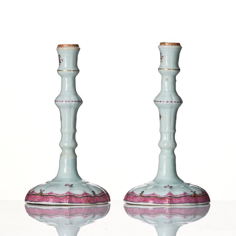 A pair of famille rose candle sticks, Qing dynasty, Qianlong (1736-95).