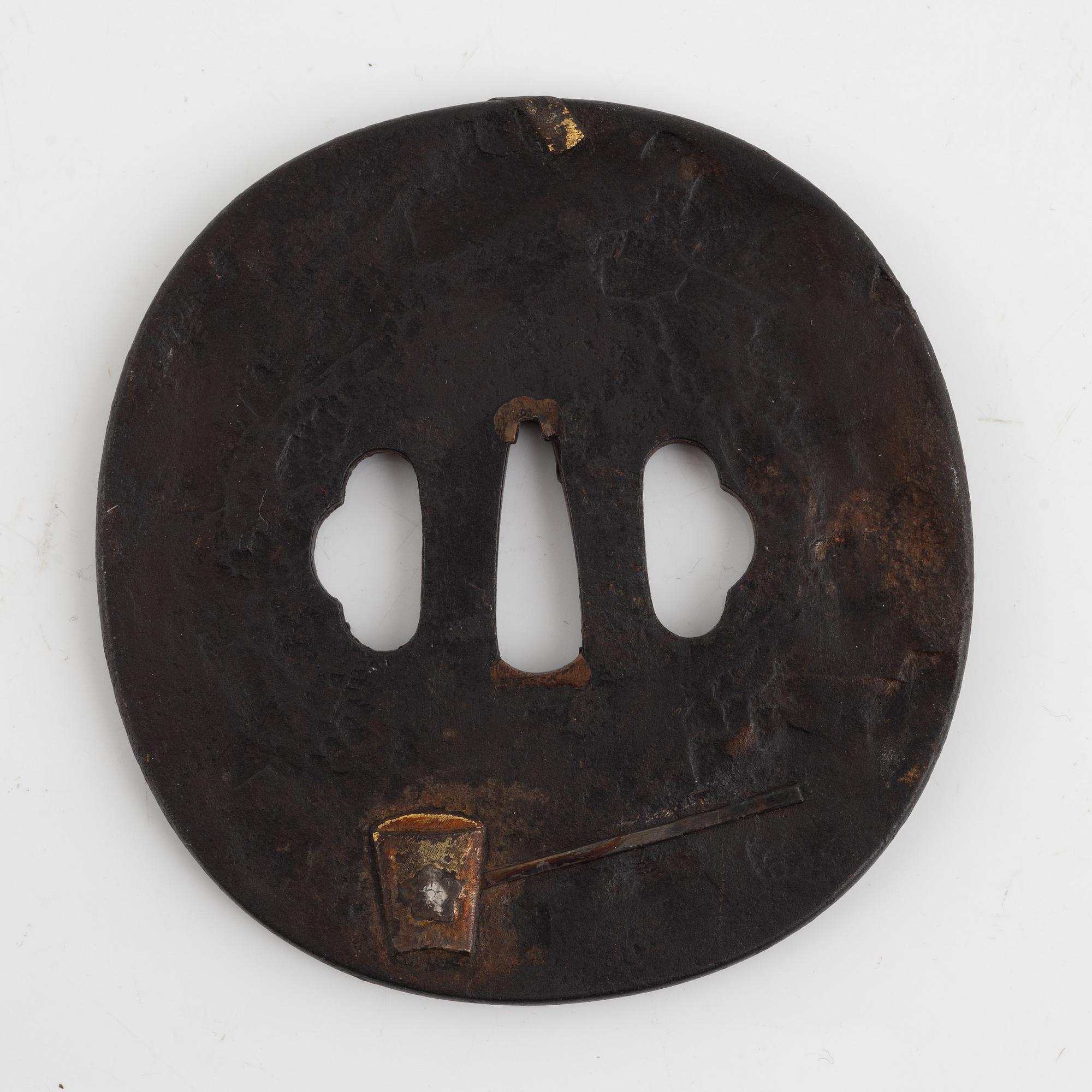 A Japanese gilt-bronze fan-shaped box and gilt iron tsuba with mei inscription, Meiji period (1868-1912).