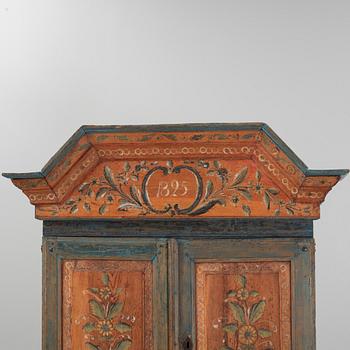 A painted cabinet, dated 1825.