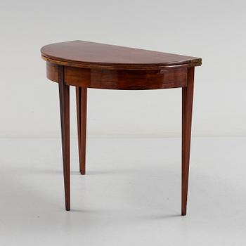 A first half od the 19th century game table veneered with mahogny.