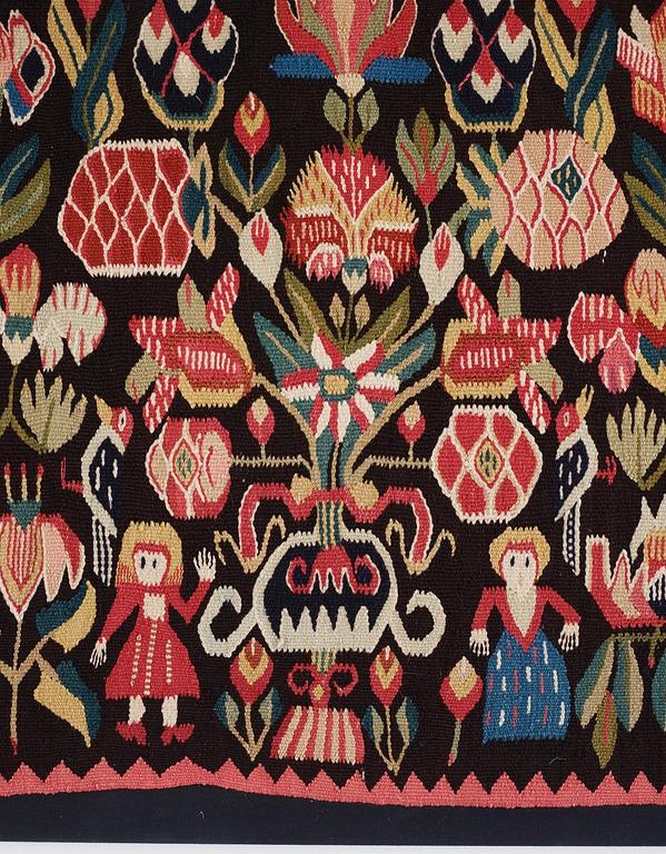 A carrige cushion, 'Urnor & par',  tapestry weave, c. 110 x 53 cm (with mounting 115 x 57 cm), circa 1800-1825.