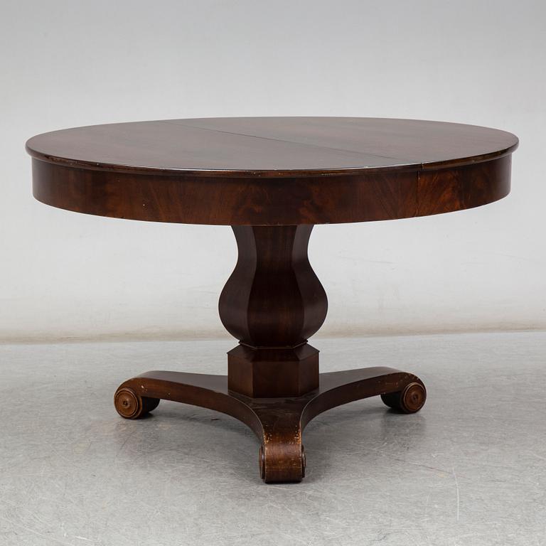 a mid 1800's mahogany dining table with three leaves.